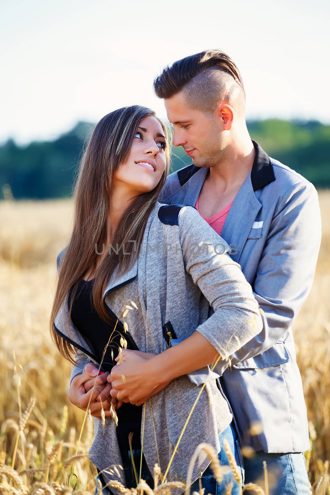 Happy smiling young couple outdoor by artush
