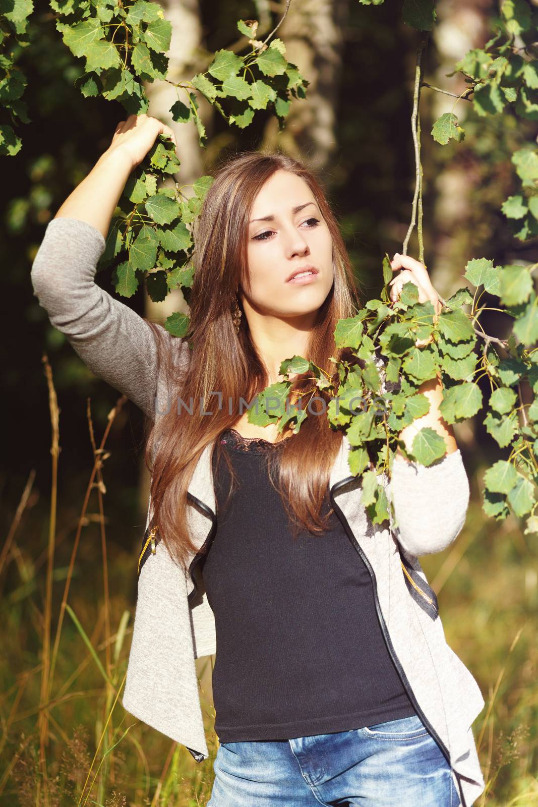 Portrait of a charming lady woman girl outdoor with forrest in background 