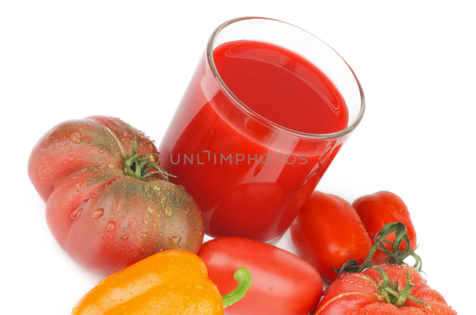Freshly Squeezed Tomato Juice with Various Tomatoes and Orange Bell Pepper closeup on White background