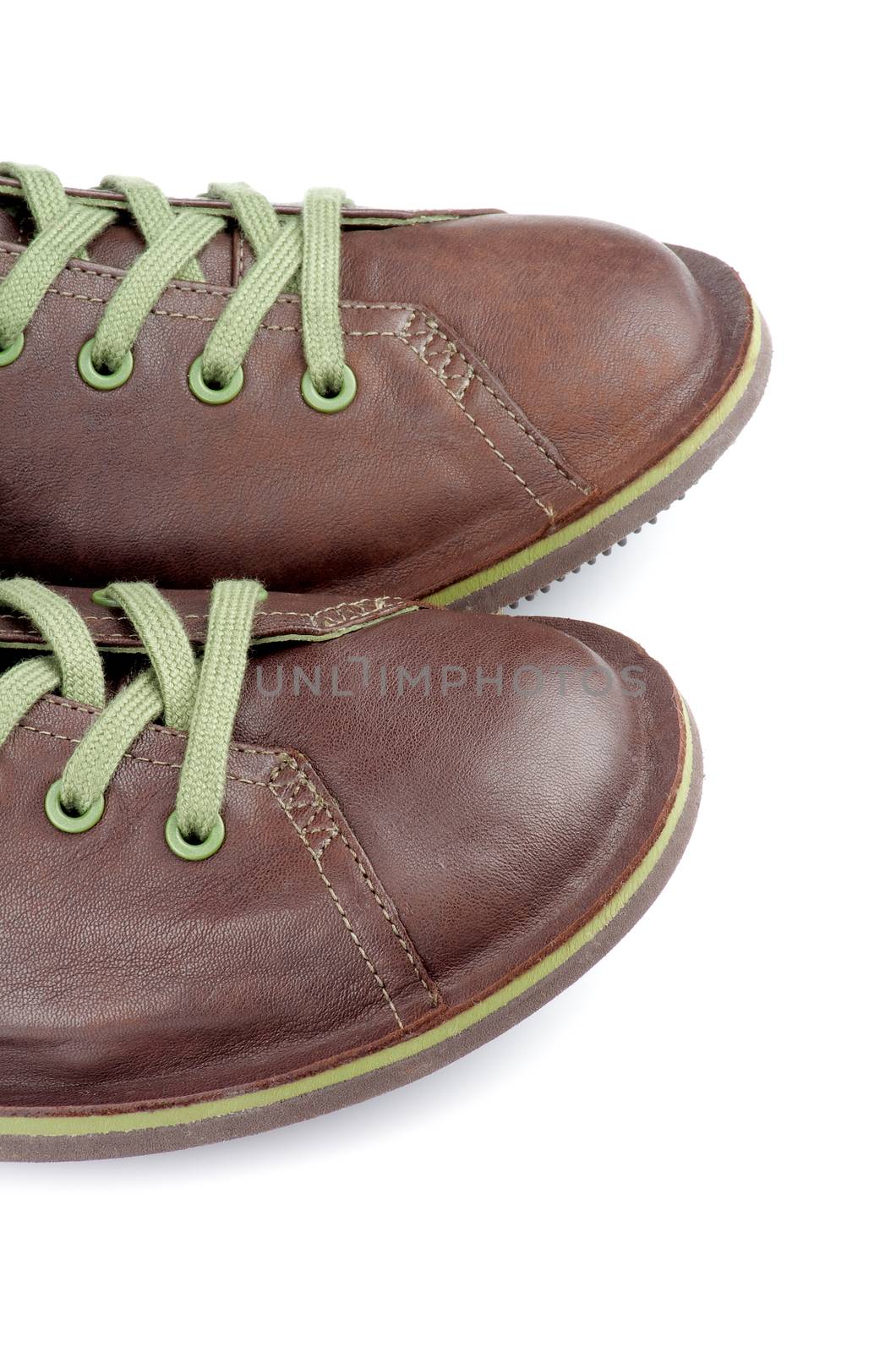 Noses of Brown Leather Men Shoes with Green Shoelaces isolated on white background