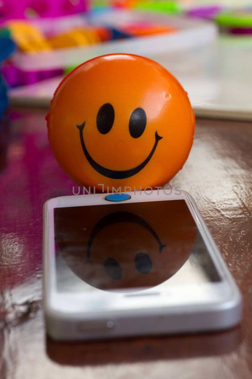 Smiling ball with moblie  phone