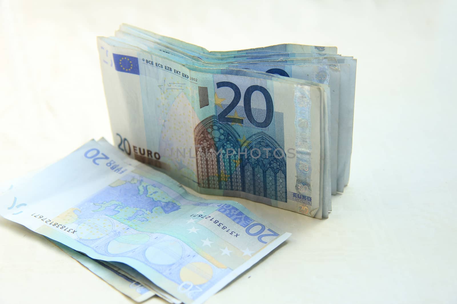 stacked 20 euro banknotes on white background