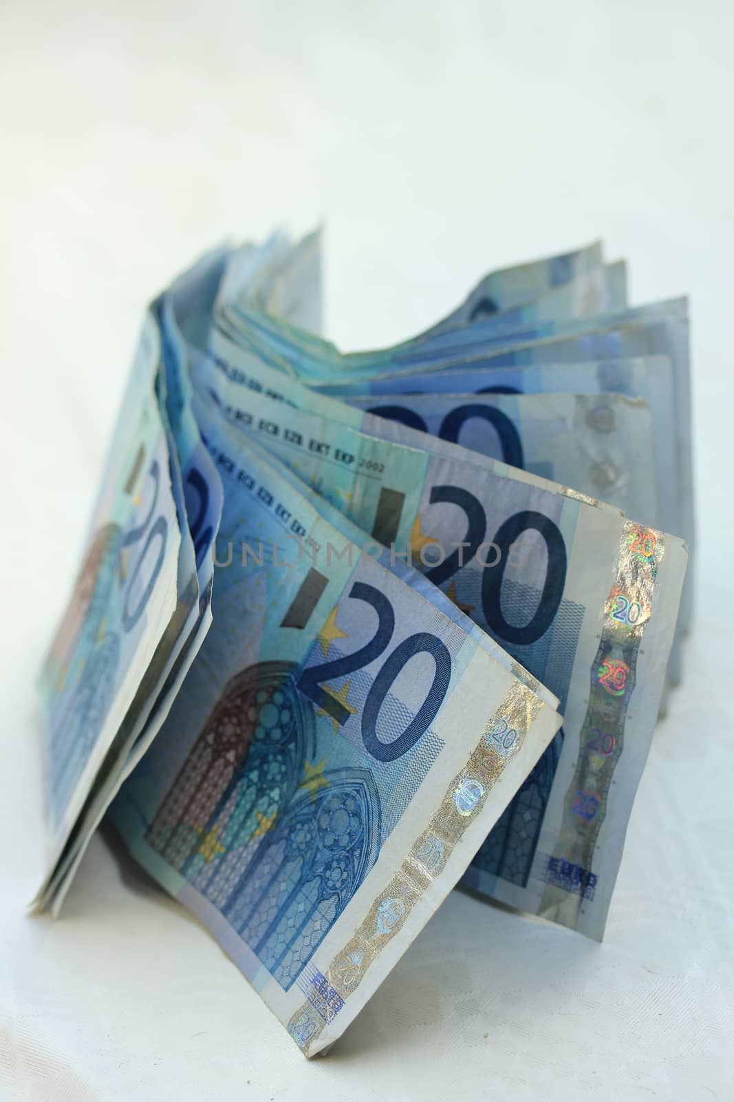 stacked 20 euro banknotes on white background