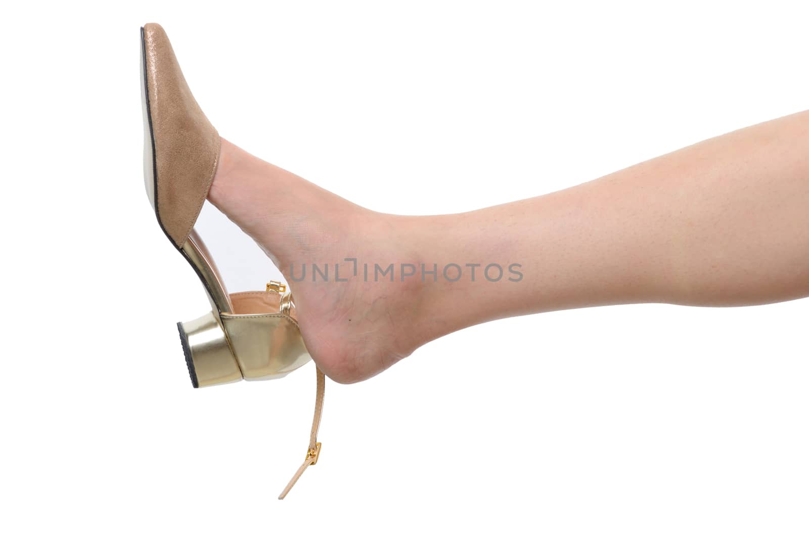 Beautiful female leg with gold shoe isolated on white background