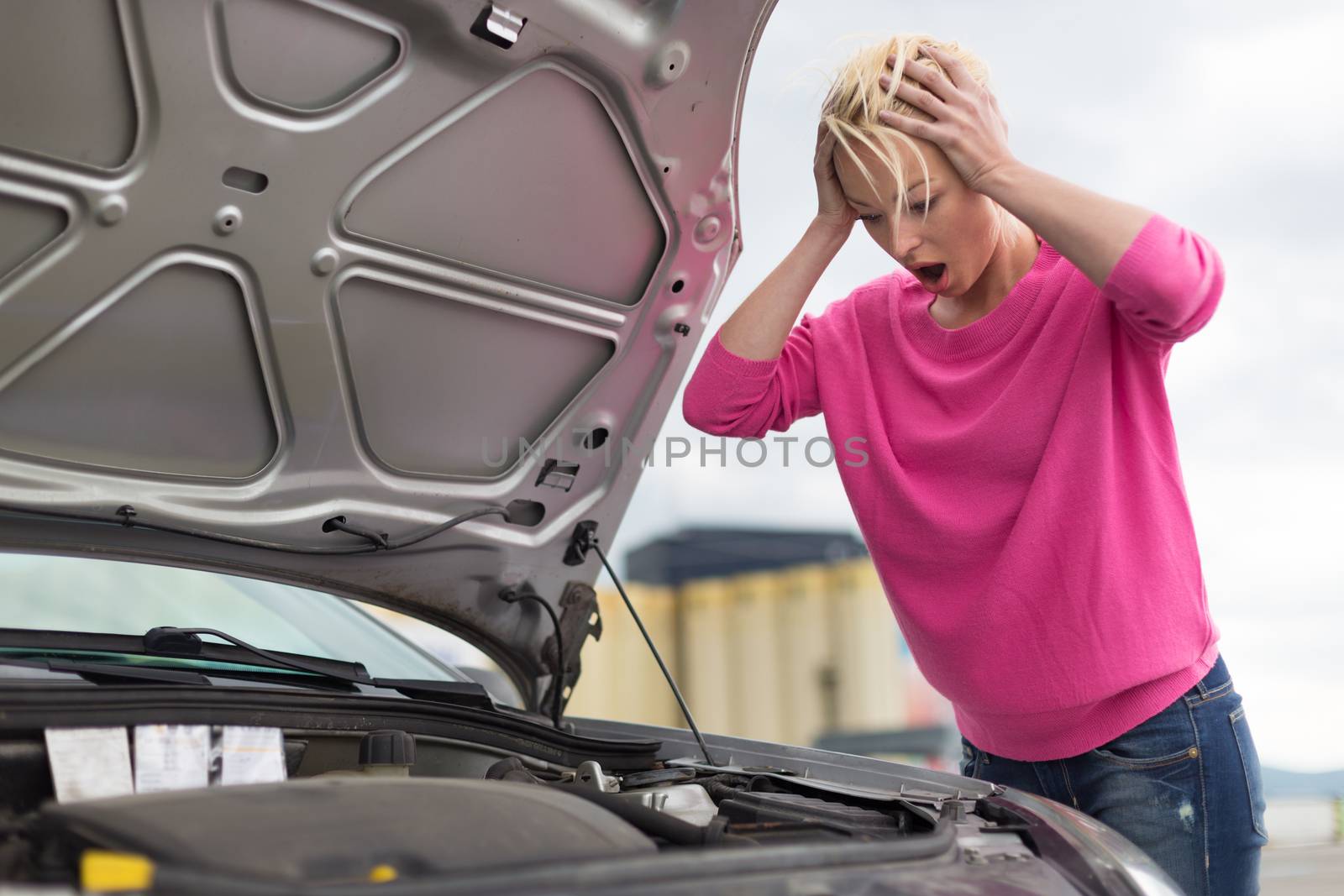 Stressed Young Woman with Car Defect. Engine breakdown.