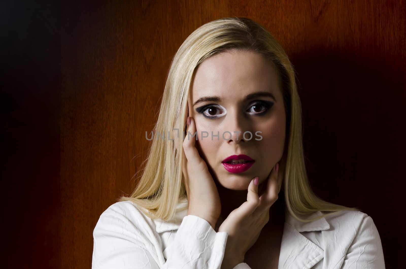 fashion portrait of a blonde woman against a wooden textured background