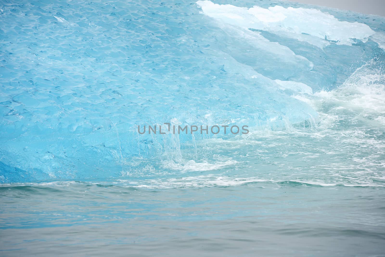 blue iceberg floating in alaska