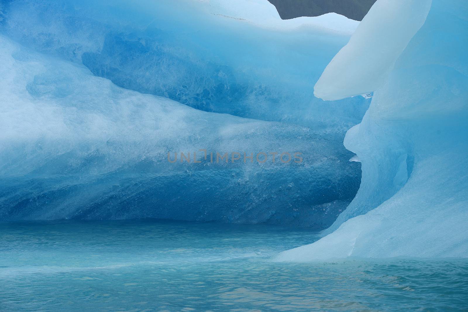 blue iceberg floating in alaska