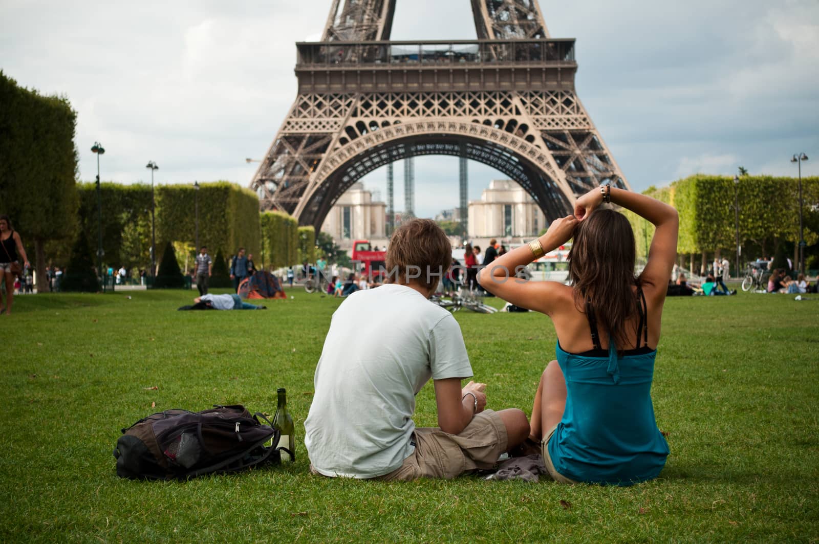 couple in Eiffel Tower in Paris by NeydtStock