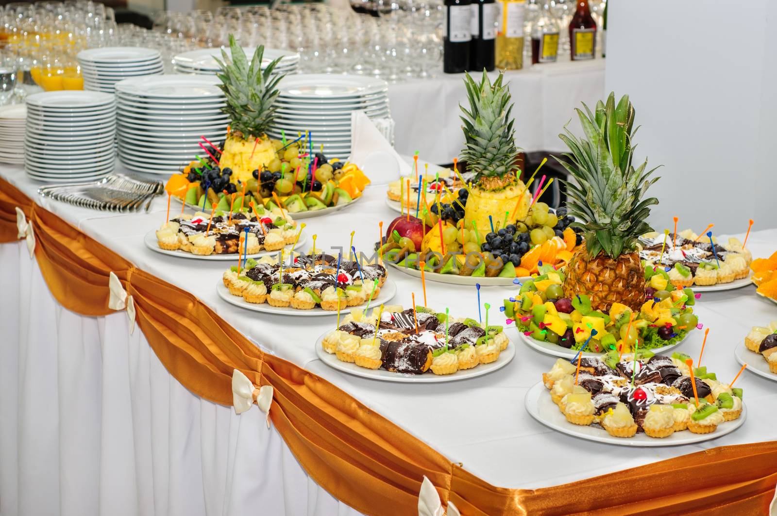 Richly served banquet dessert table with fruits and cakes