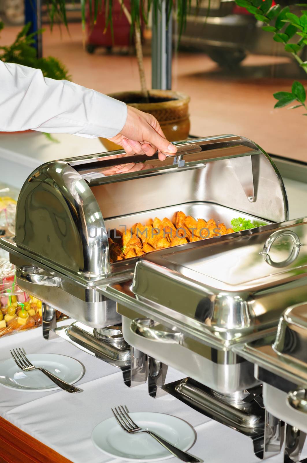 chafing dish heater filled with ready grilled meat inside