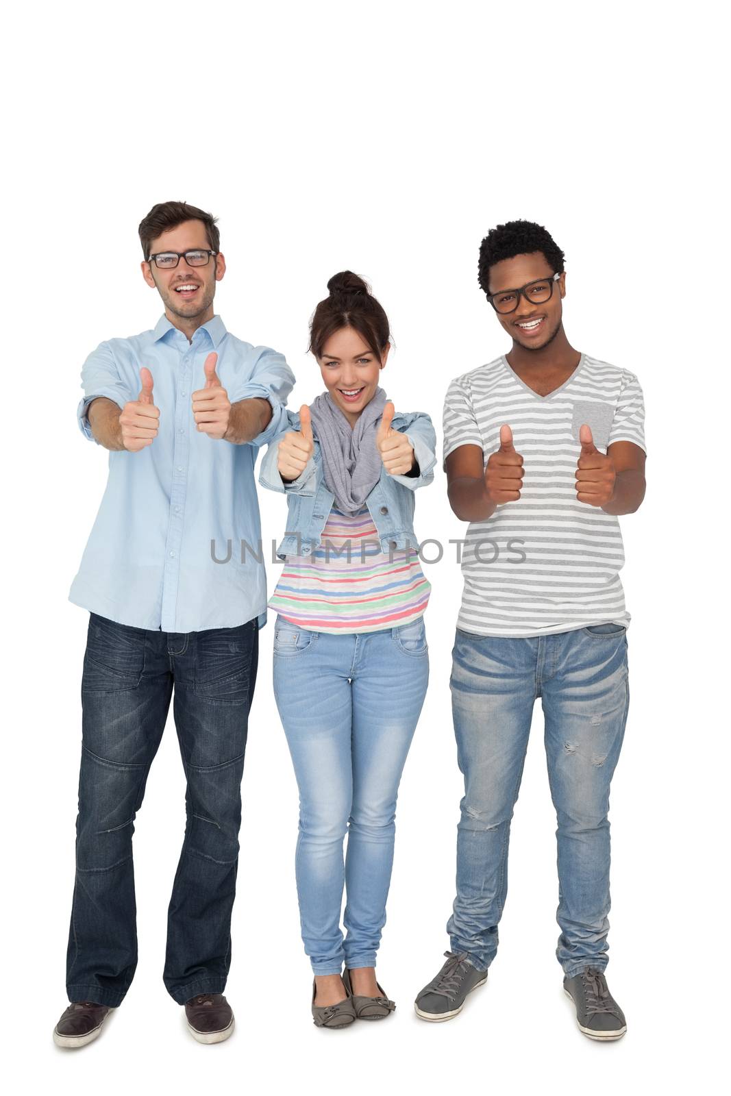 Full length portrait of three happy friends gesturing thumbs up over white background