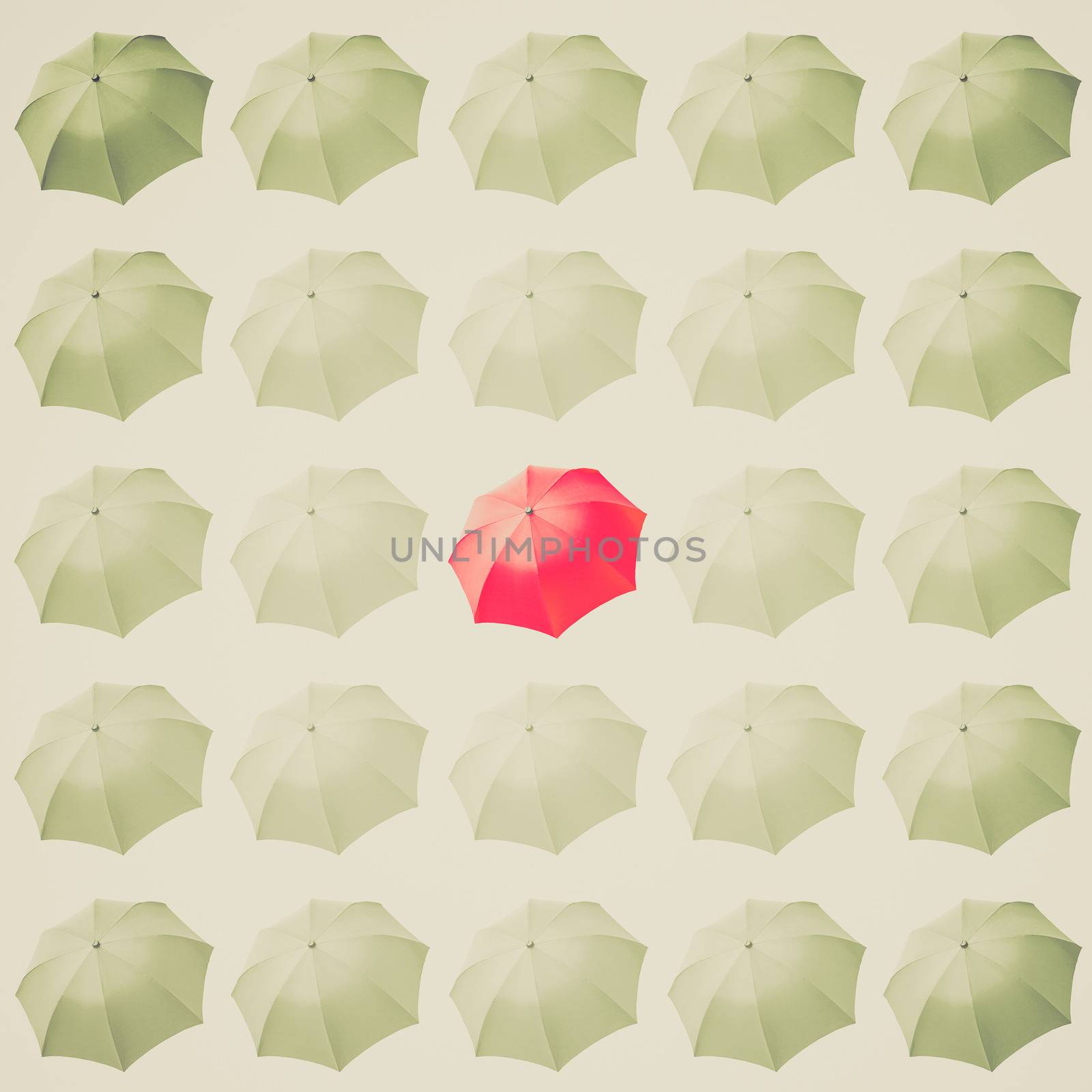 Vintage retro looking Single red umbrella among many white umbrellas