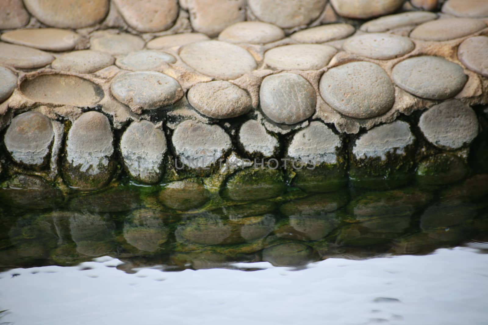 The rock's reflect in the water,it made from circle and egg-shape with in the lime.