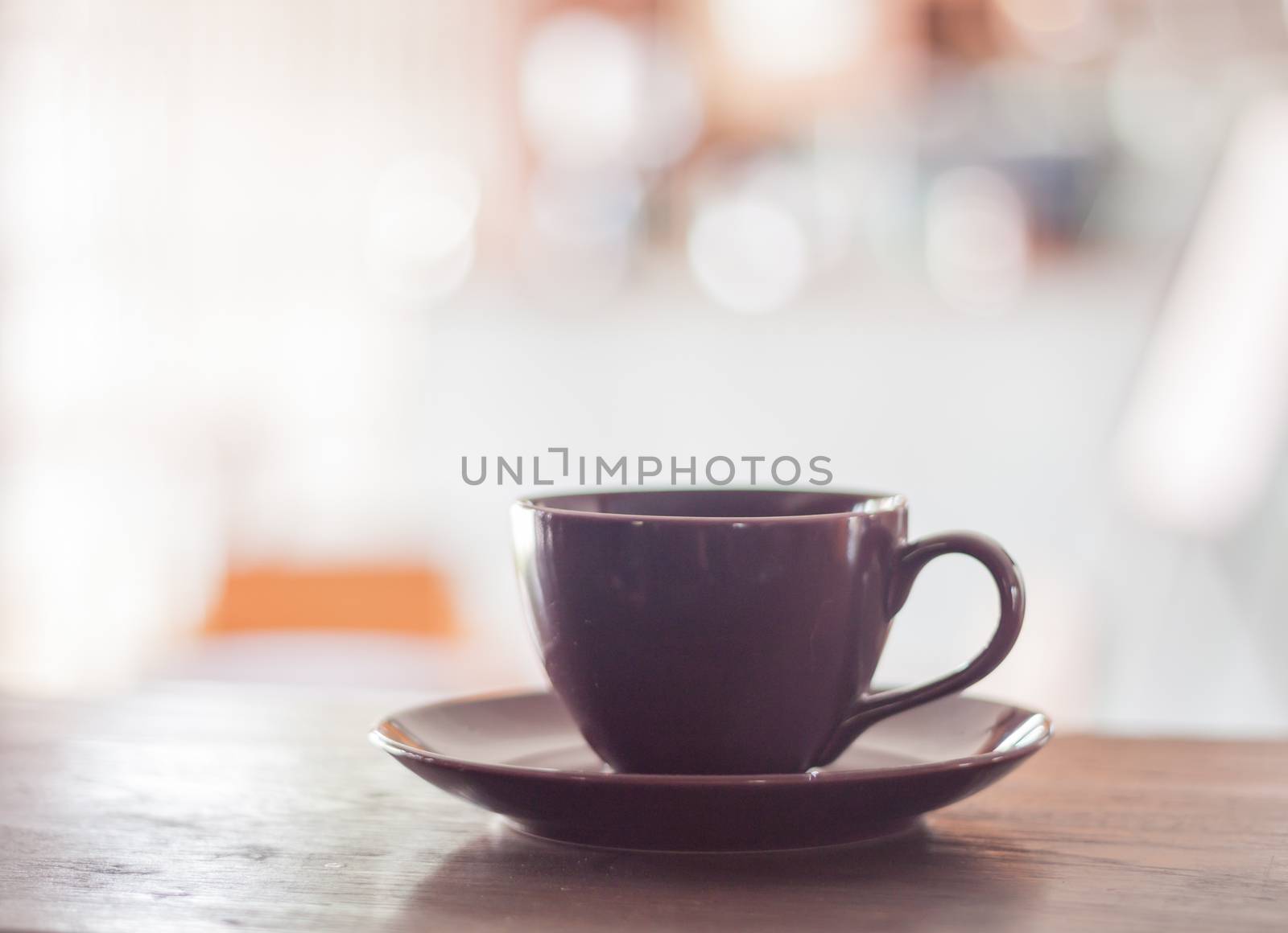 Purple coffee cup on wooden table, stock photo