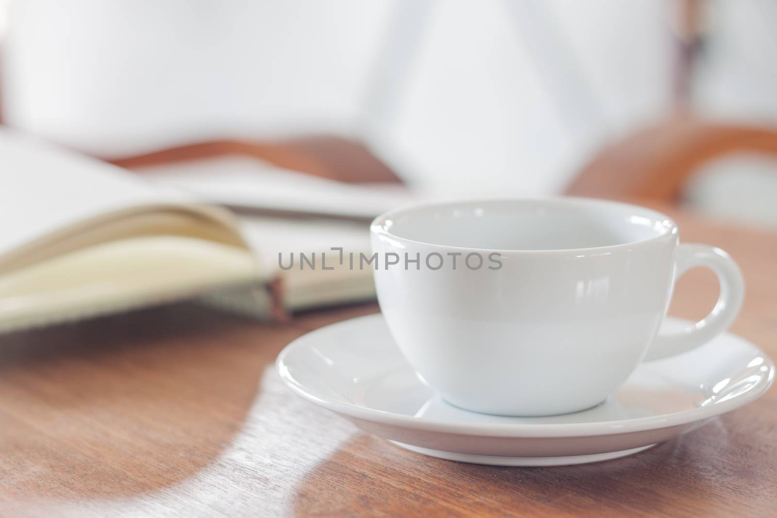 White coffee cup with notebook by punsayaporn