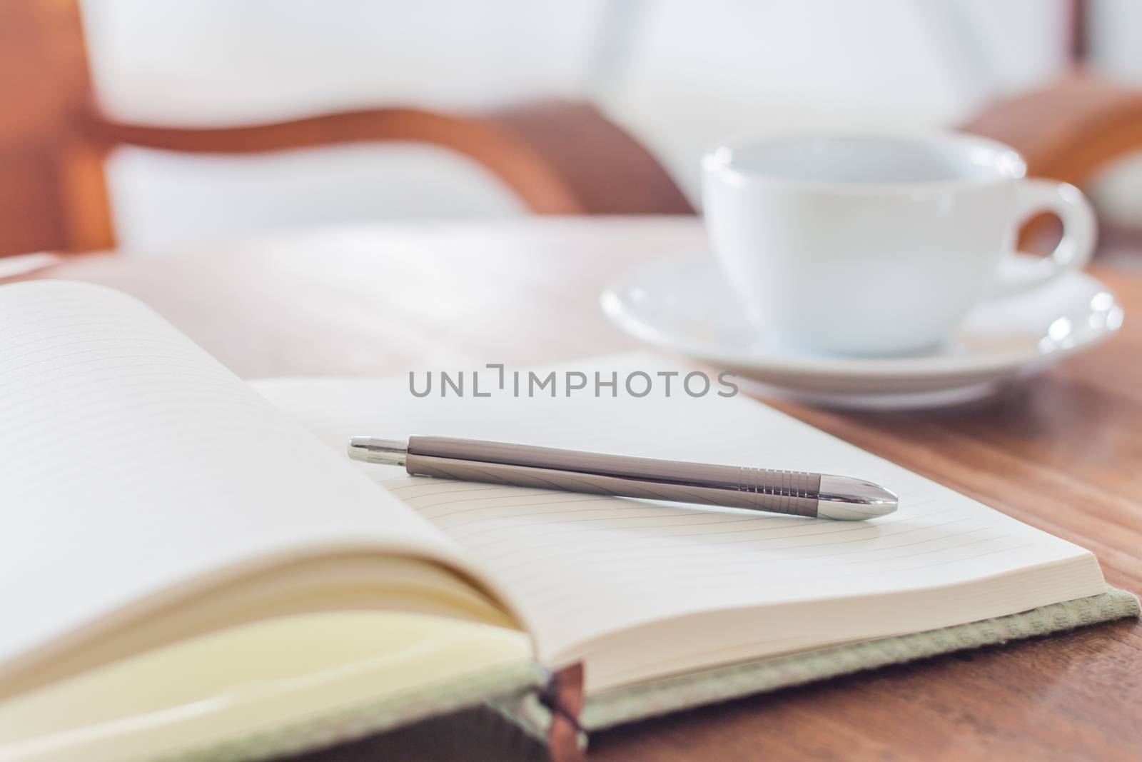 Notebook and pen with coffee cup, stock photo