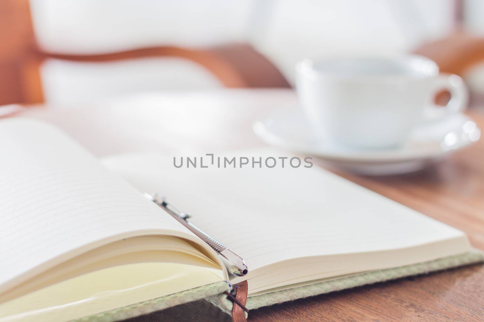 Open a blank white notebook and pen with a cup of coffee, stock photo