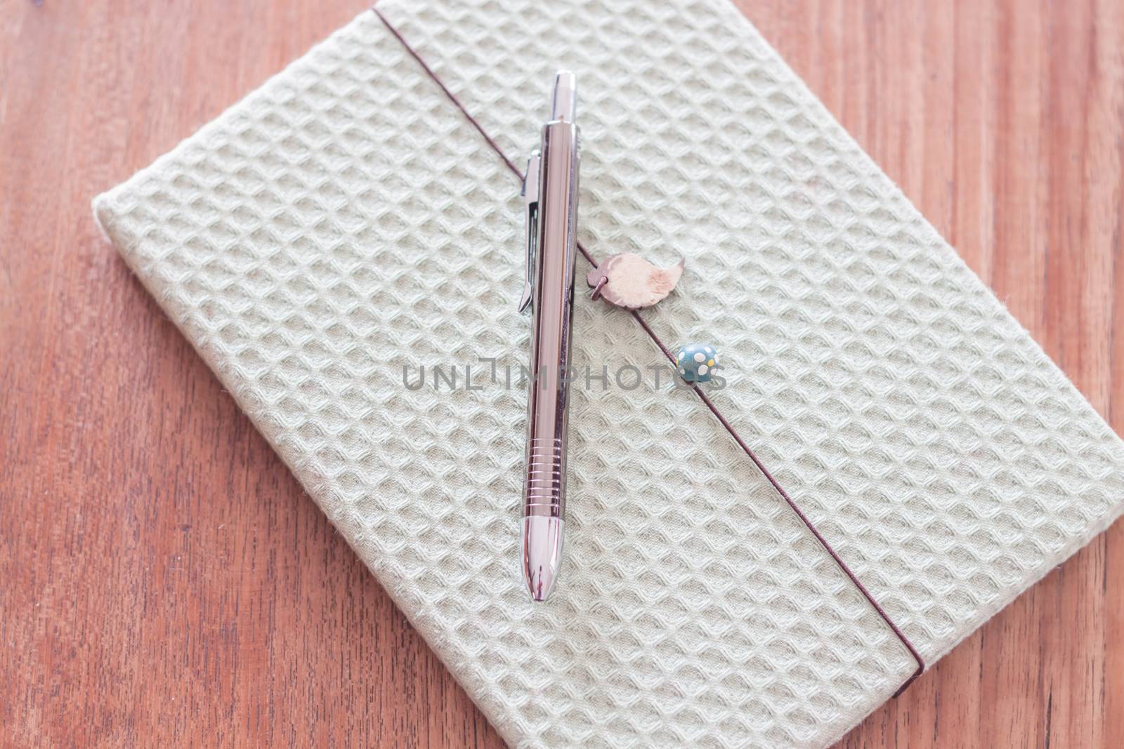 Green cover notebook with pen by punsayaporn