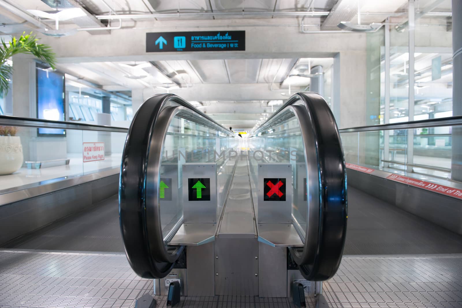 airport escalator with unrecognizable people walking on
