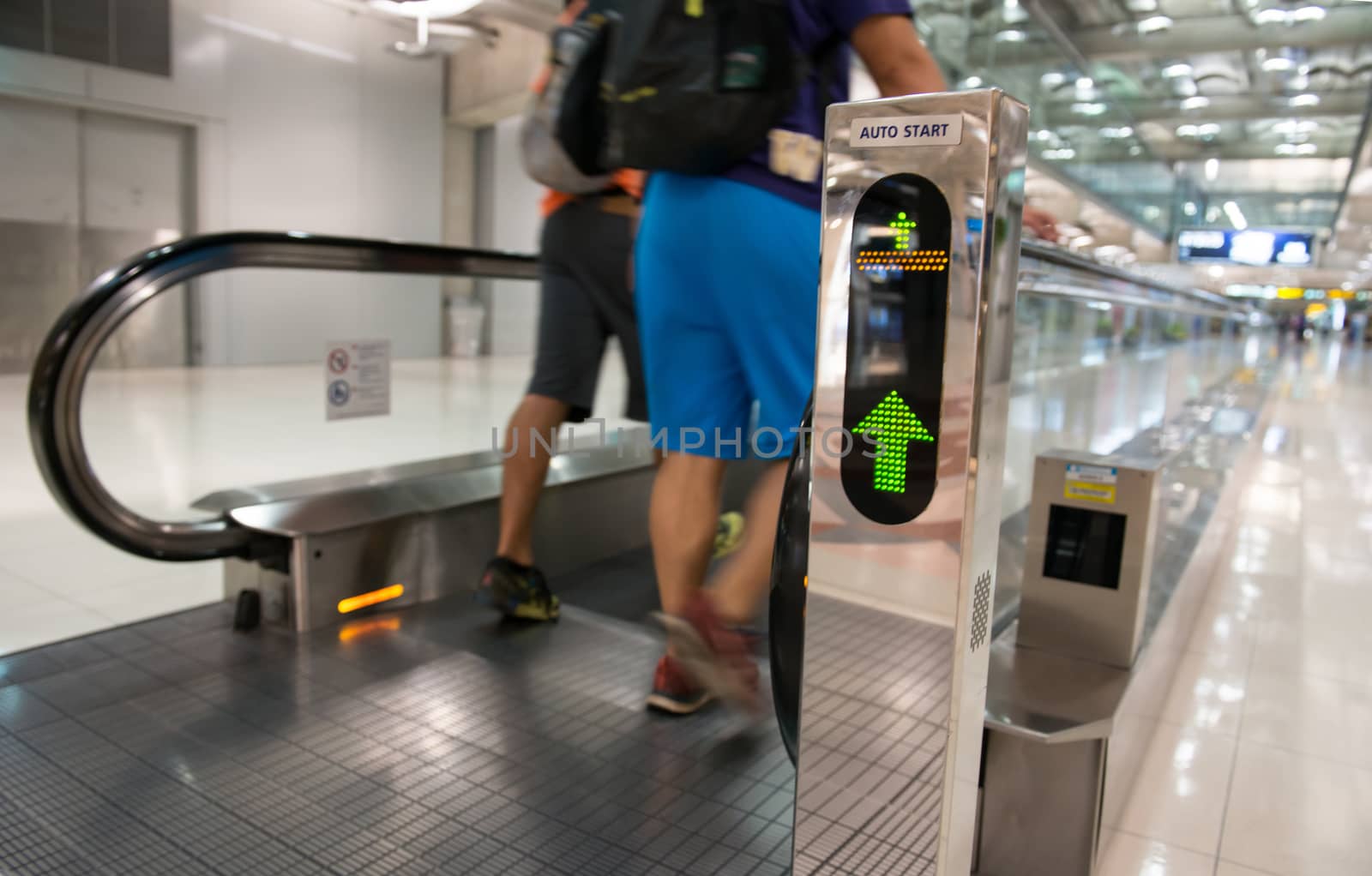 airport escalator with unrecognizable people walking on