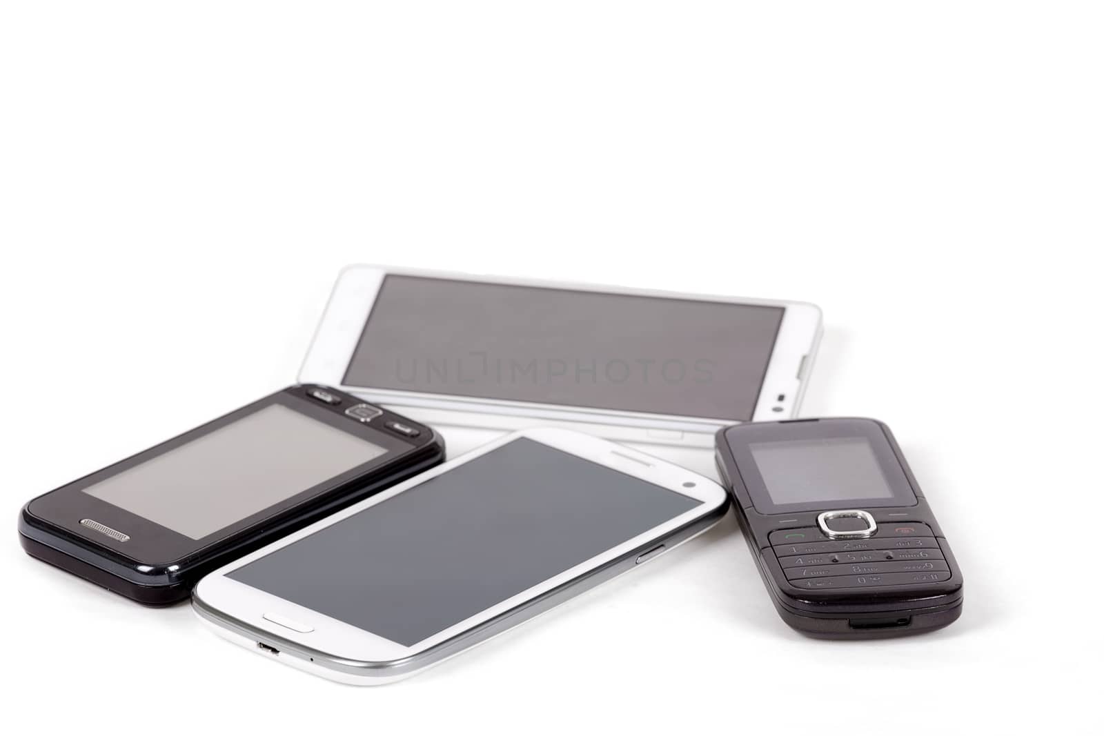 collection of cell phones, old design and new smart phones isolated on white