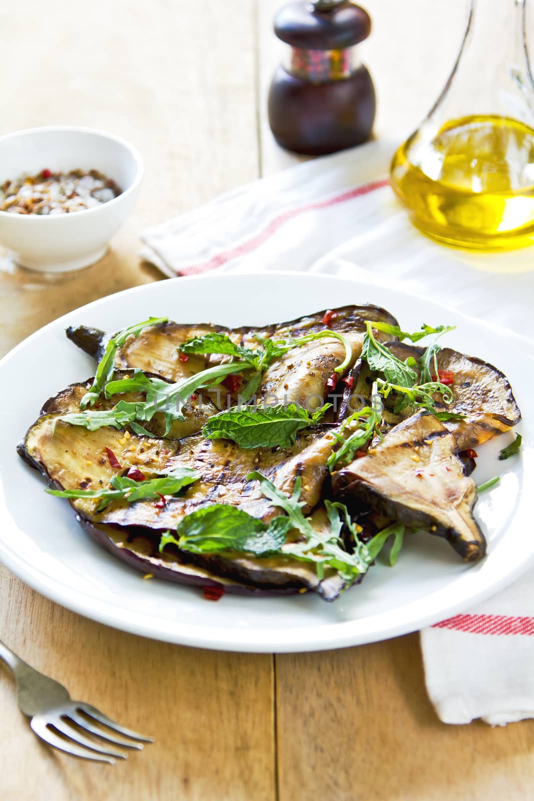 Grilled Aubergine salad with dried chili flake and Rocket