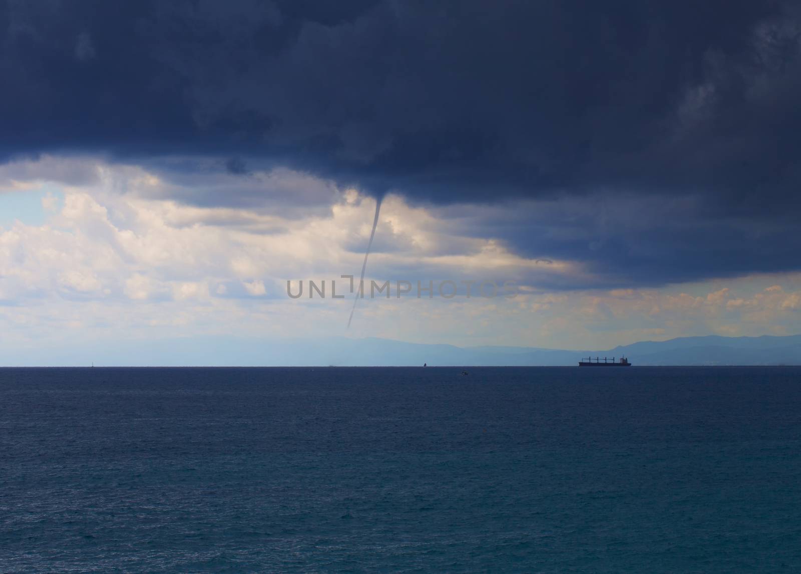 Whirlwind over the sea, with ships at the horizon