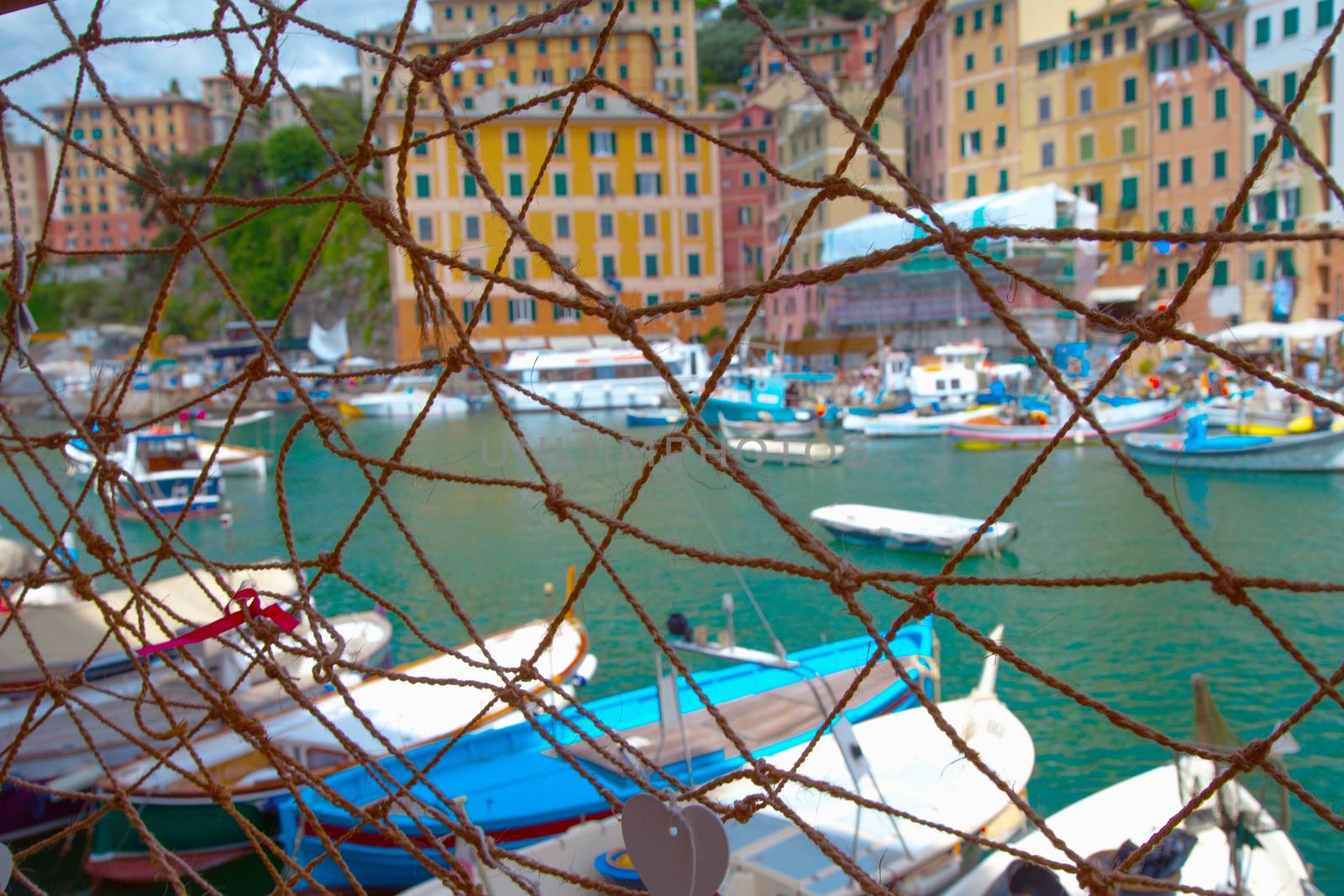 Small port behind a fishnet, horizontal image