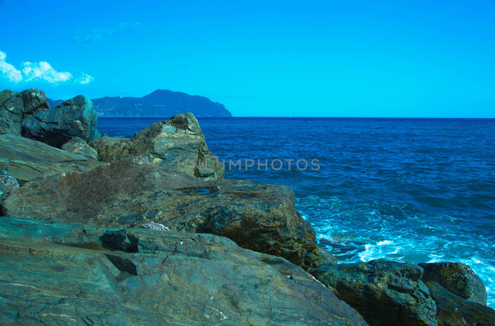 Rocks on the coast with deep blue sea on the back, horizontal image