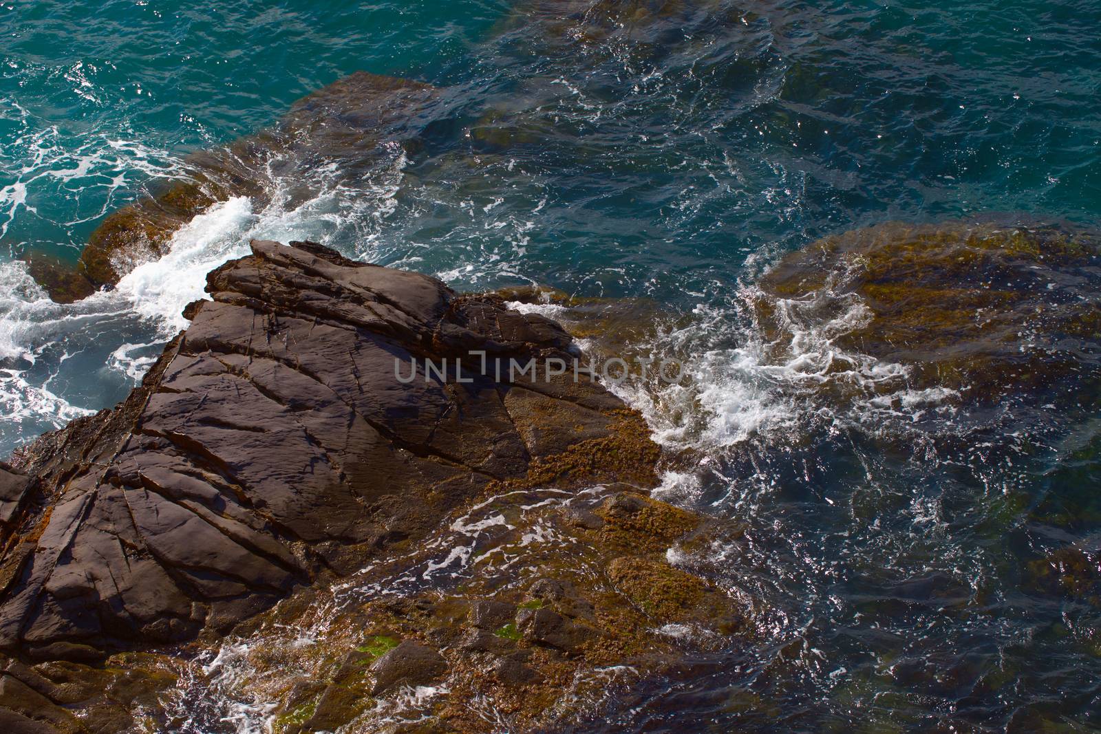 Rocks on the coast with deep blue sea on the back, horizontal image