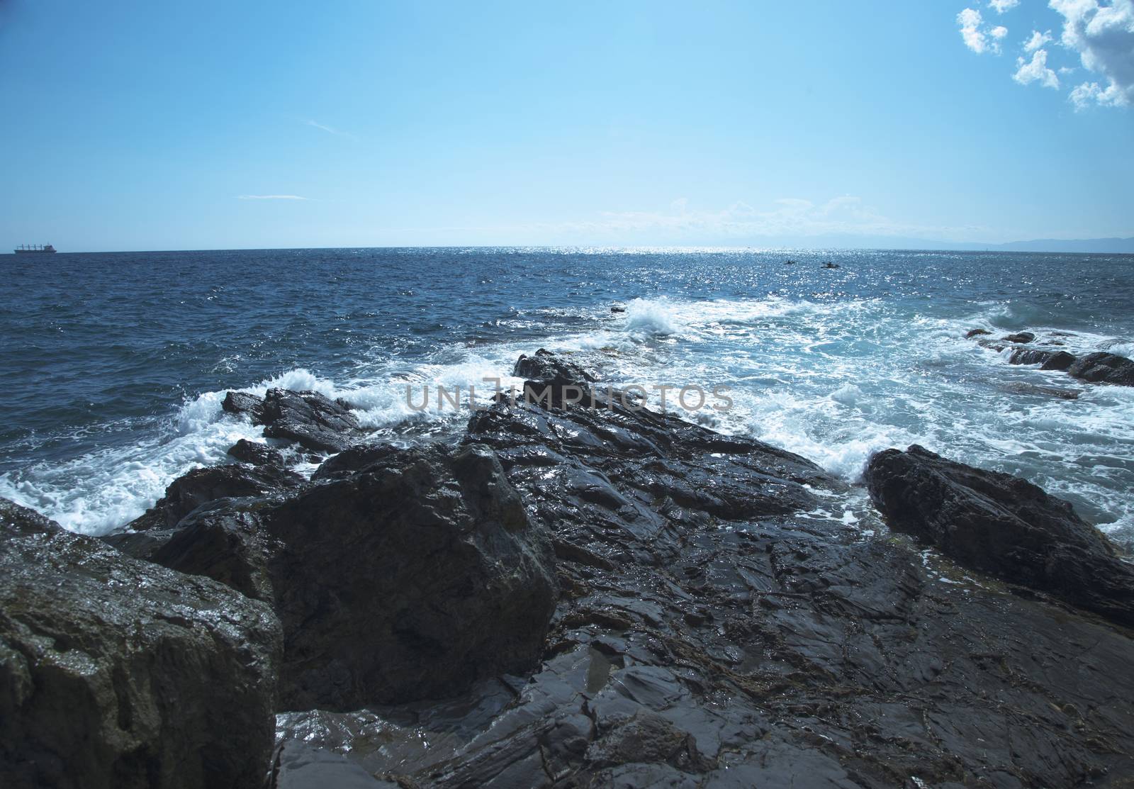 Rocks on the coast with deep blue sea on the back, horizontal image