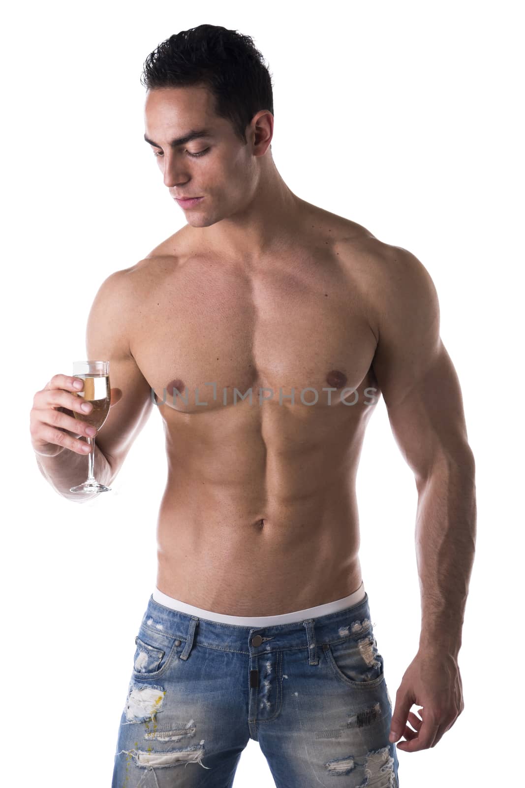 Romantic handsome muscular shirtless young man looking at a flute of sparkling champagne isolated on white