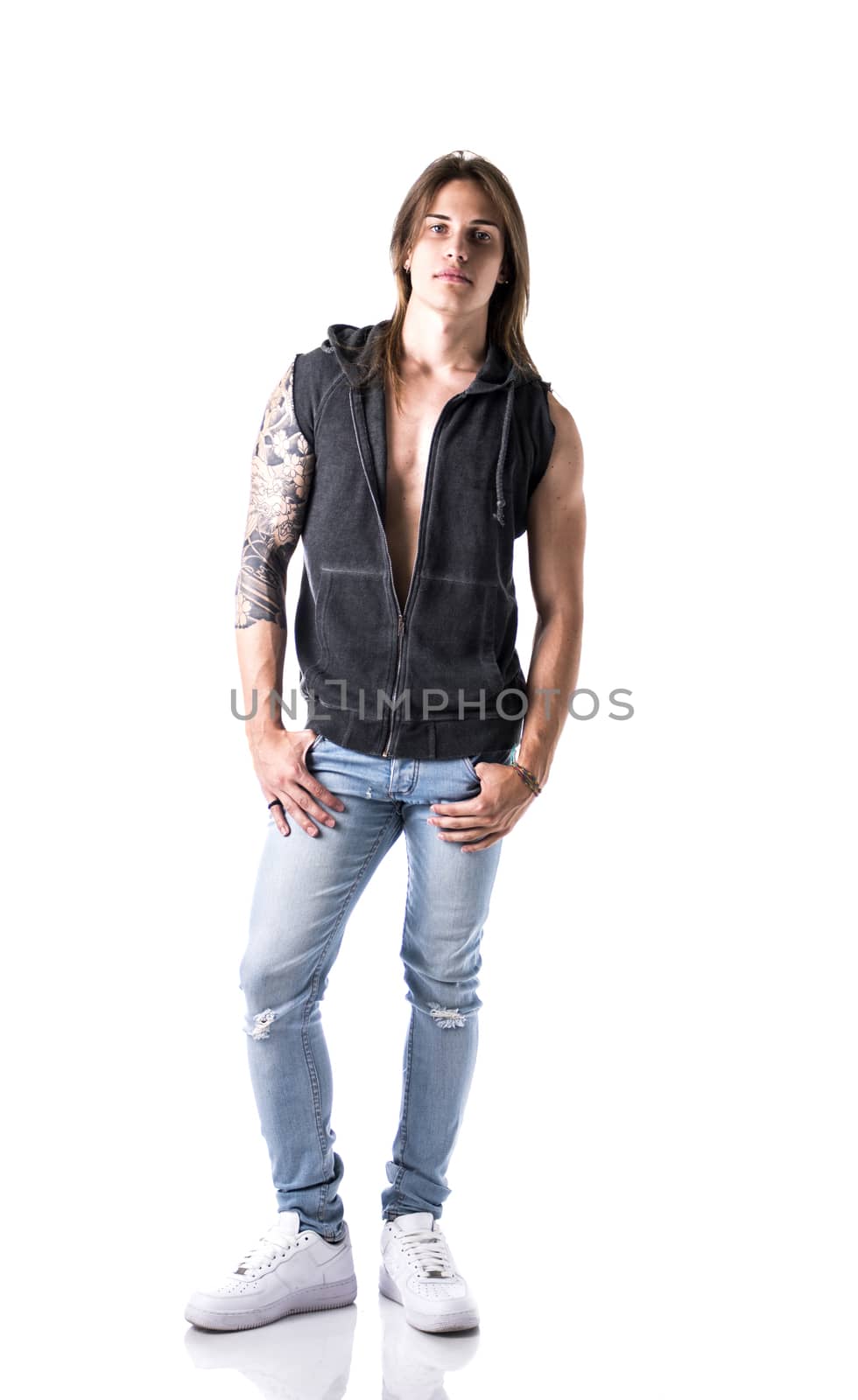 Full length shot of beautiful young long haired man in jacket posing, isolated on white