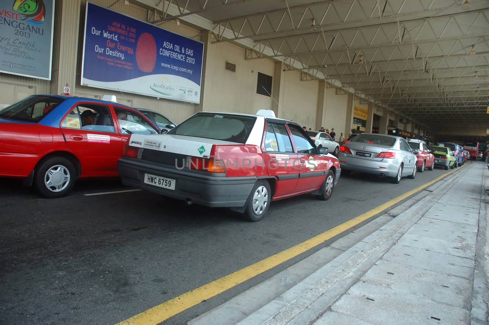 KLCCT, Malaysia - June 7, 2013: Red colored taxi that operated in Kuala Lumpur Low Cost Carrier Terminal (KLCCT), Malaysia.