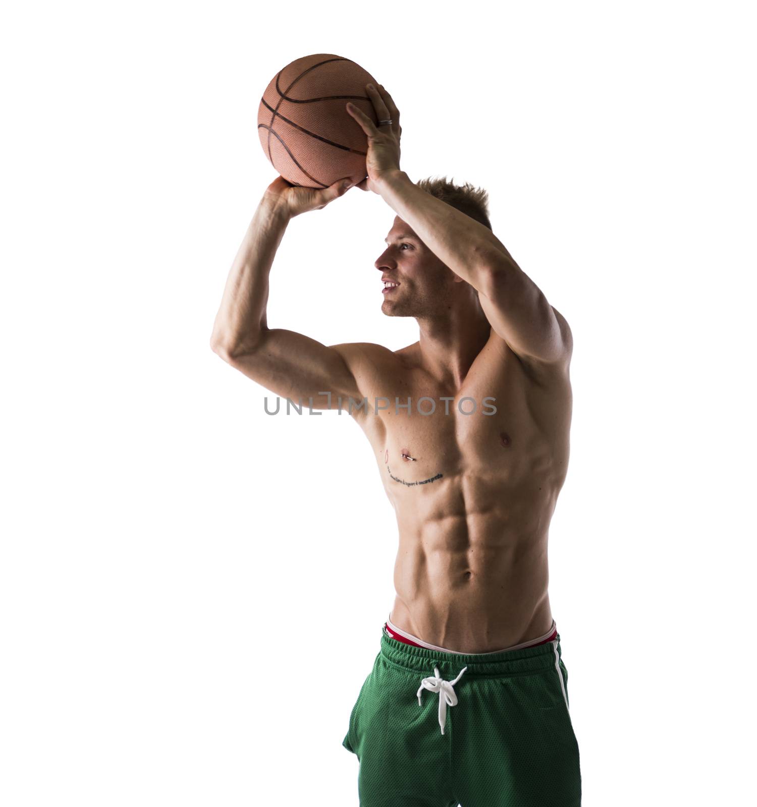 Sexy portrait of a very muscular blond shirtless male model throwing basketball ball isolated on white