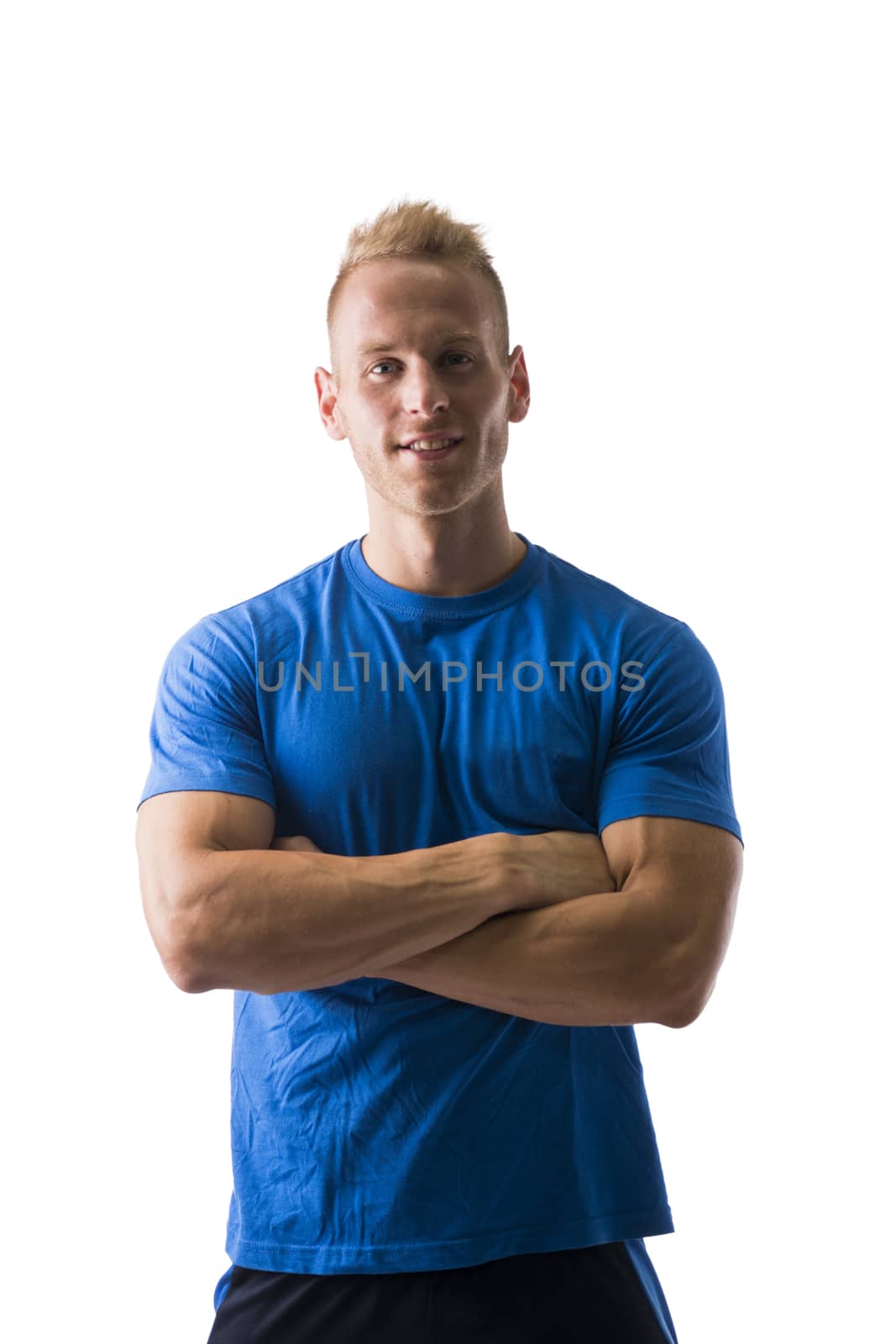 Fit male model posing with a lot of confidence, arms crossed on his chest, isolated on white