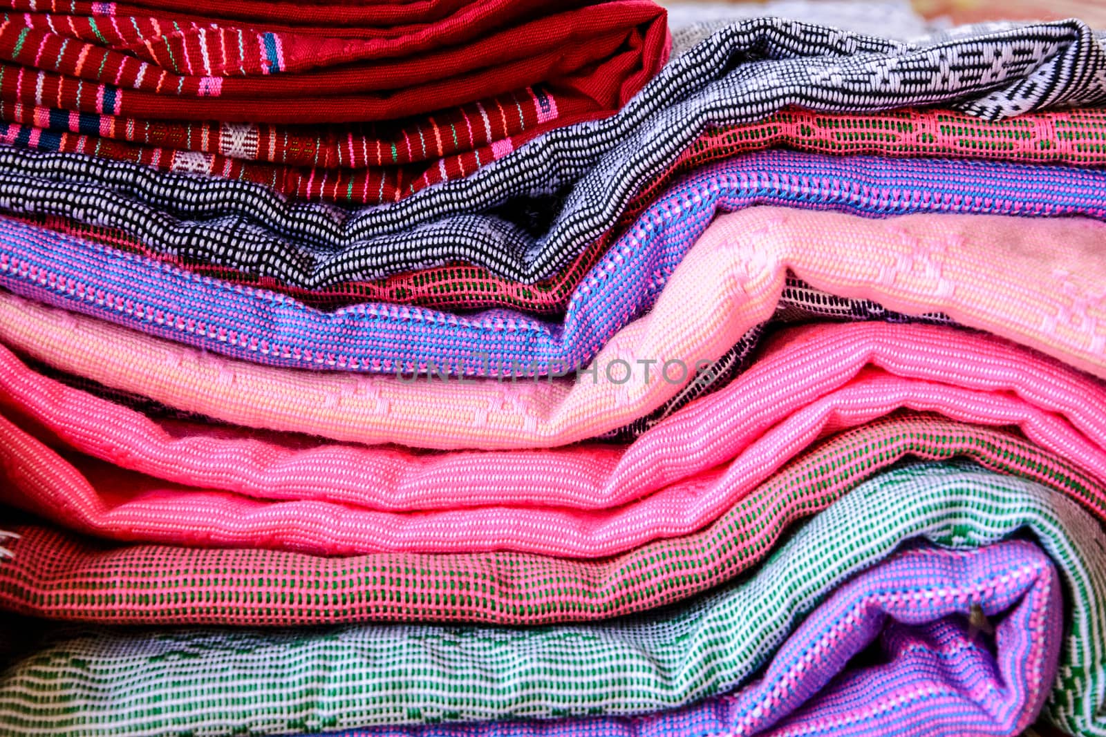 Stack of handmade woven fabrics in thailand 