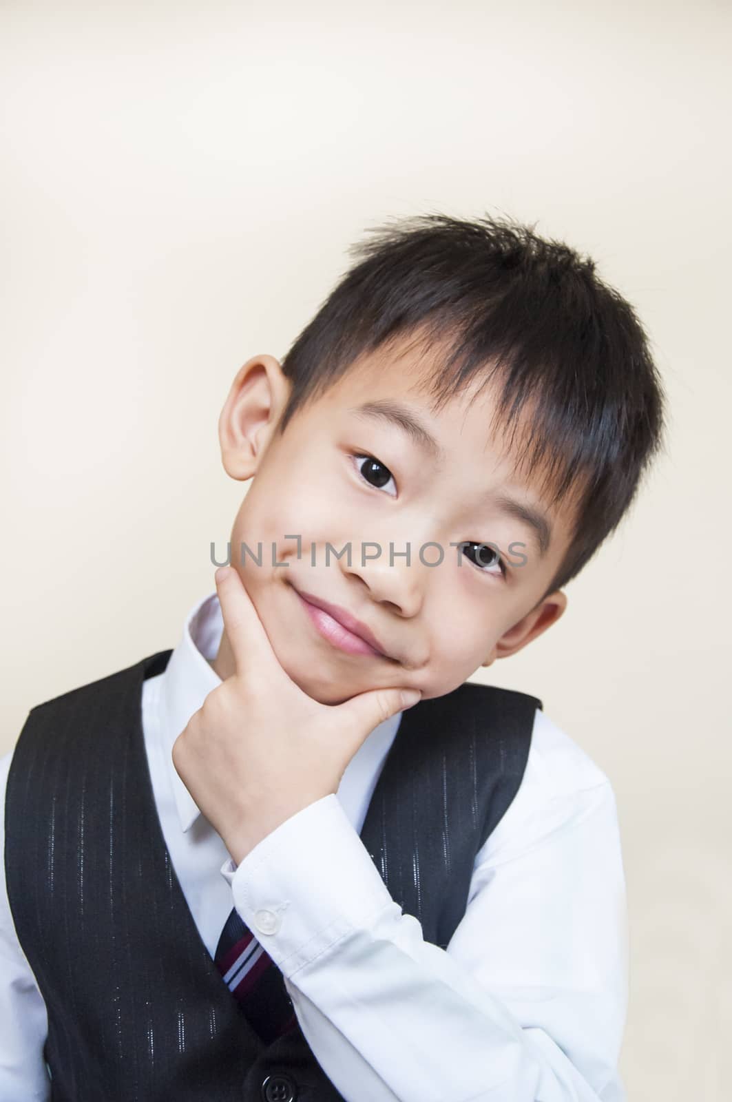 Young boy with hands on chin by joneshon