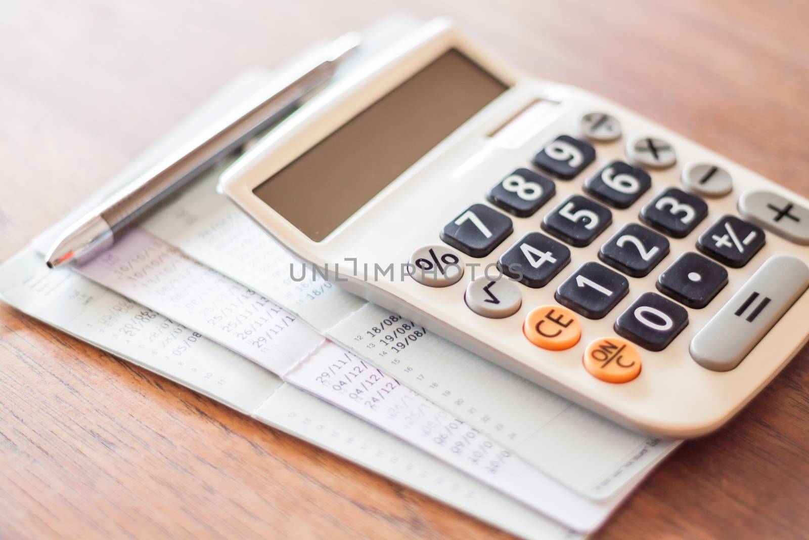 Calculator and pen with bank account passbook, stock photo