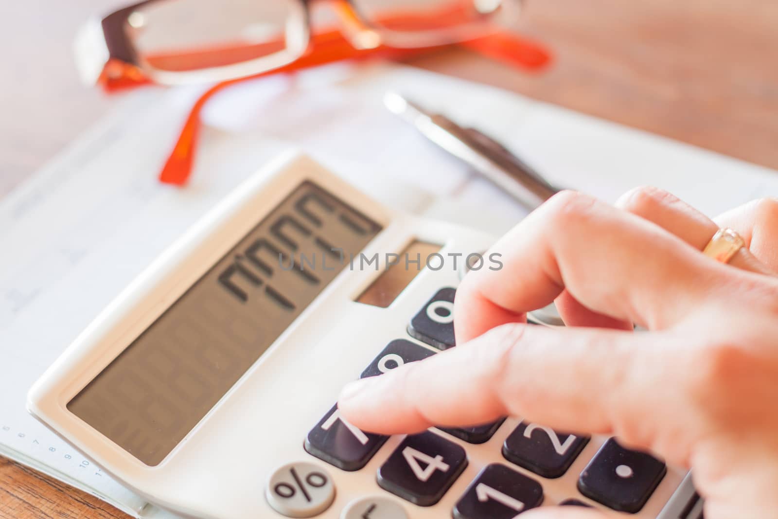 Businesswoman working with calculator by punsayaporn