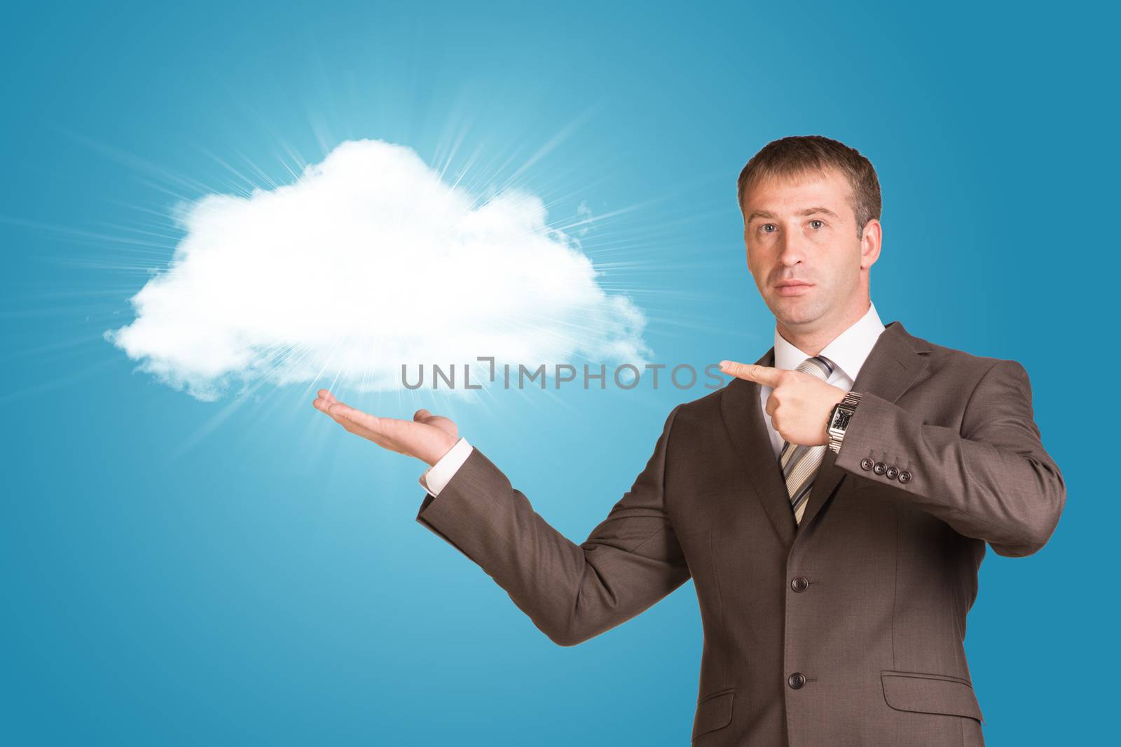 Businessman in a suit hold cloud on blue background with copy space