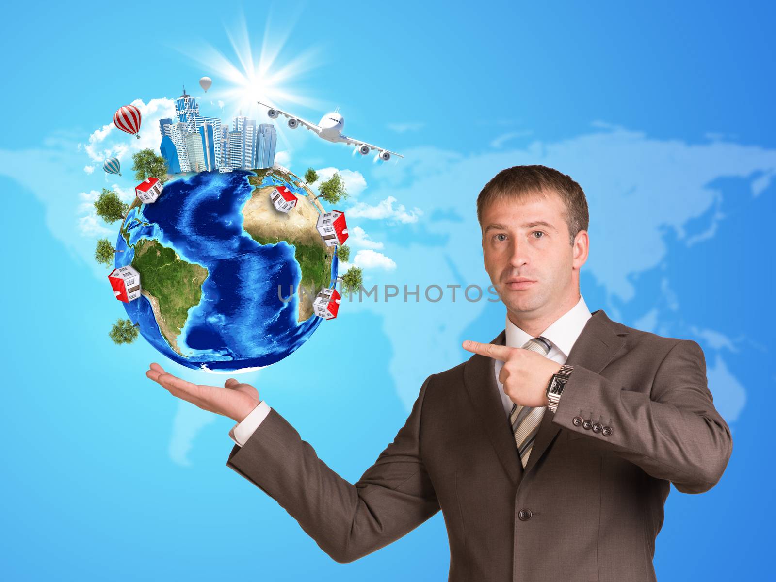 Businessman in a suit hold Earth with buildings by cherezoff