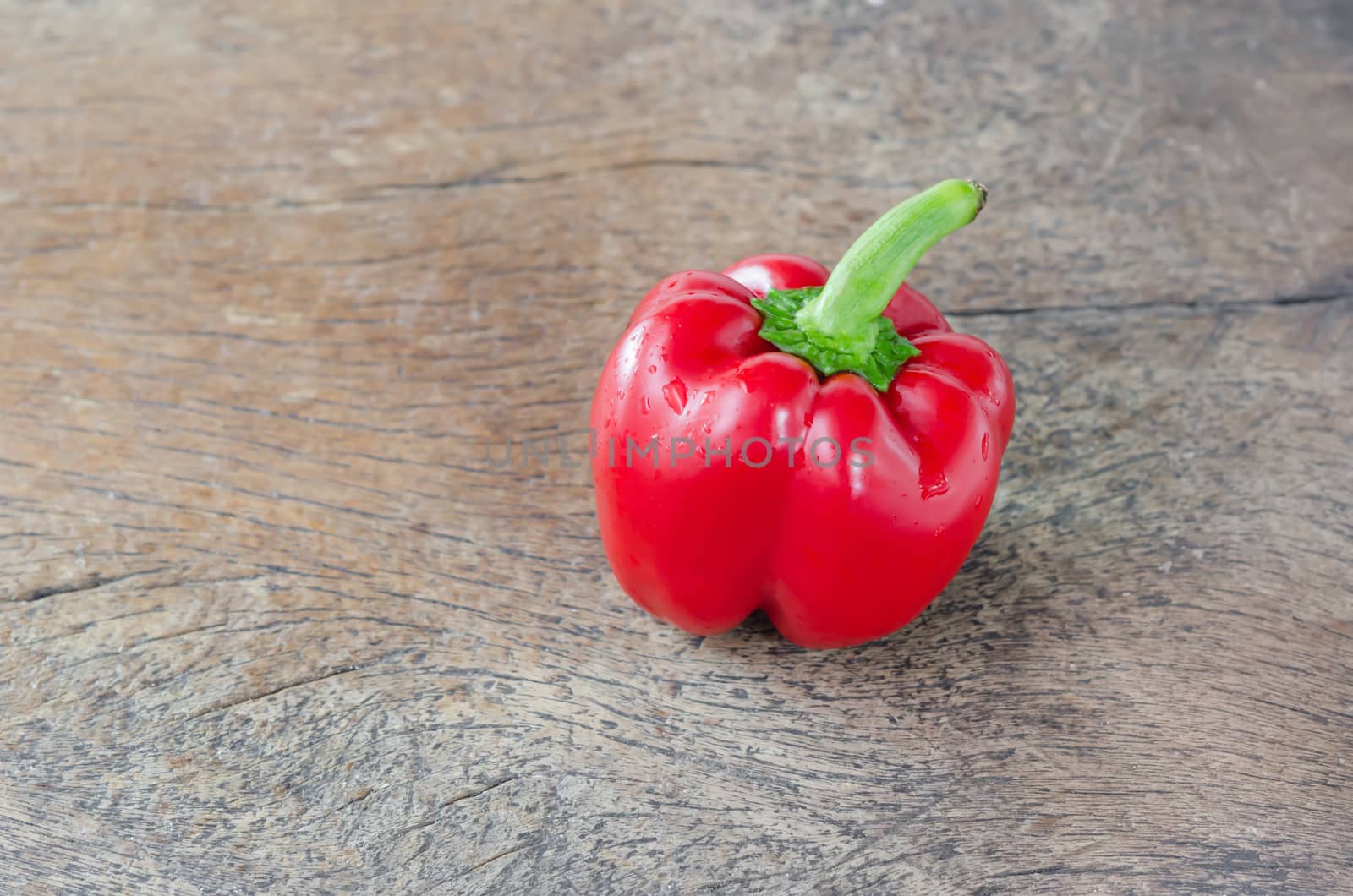organic red bell peppers on wooden table