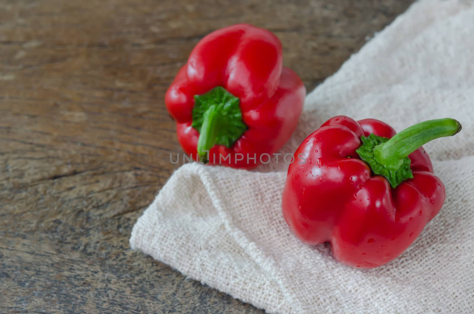 close up red bell peppers on wooden table