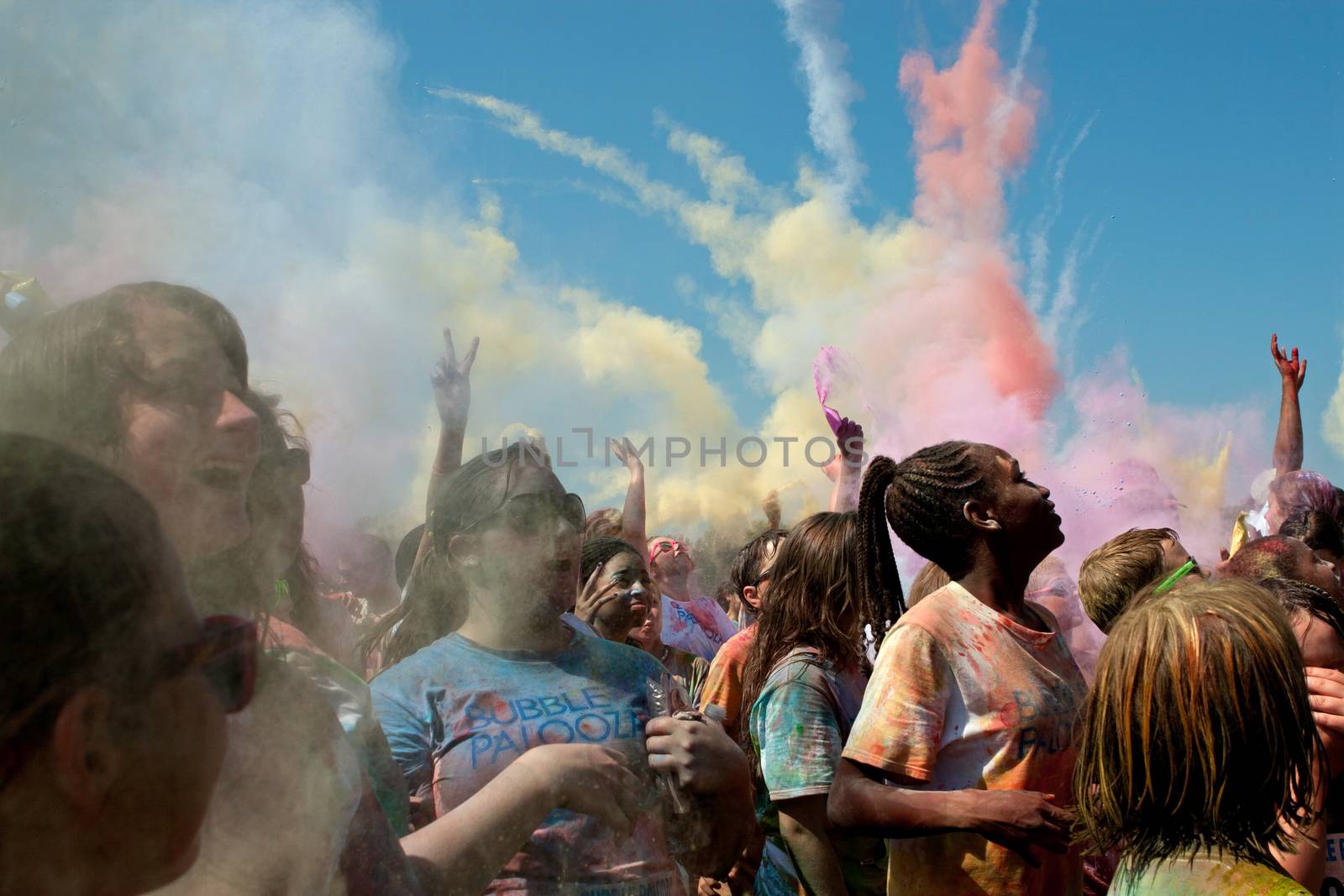 Lawrenceville, GA, USA - May 31, 2014:  People throw packets of colored corn starch in the air to create a color explosion at Bubble Palooza.