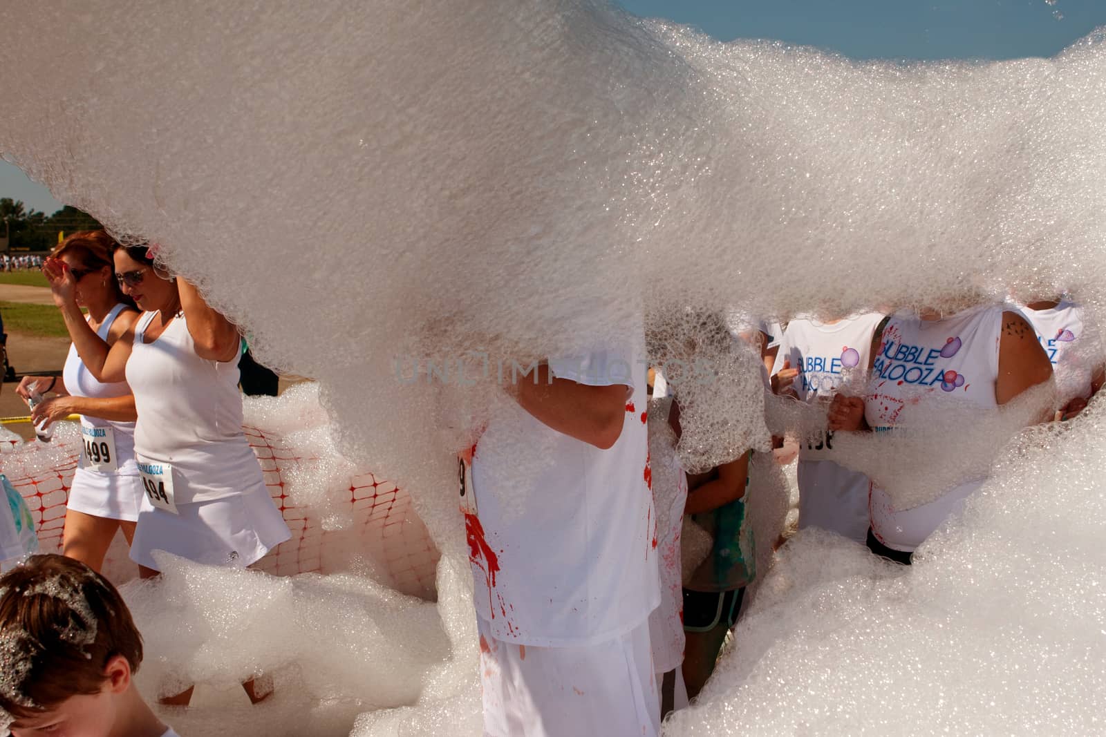 Lawrenceville, GA, USA - May 31, 2014:  People walk through a huge cloud of bubbles and foam at Bubble Palooza.