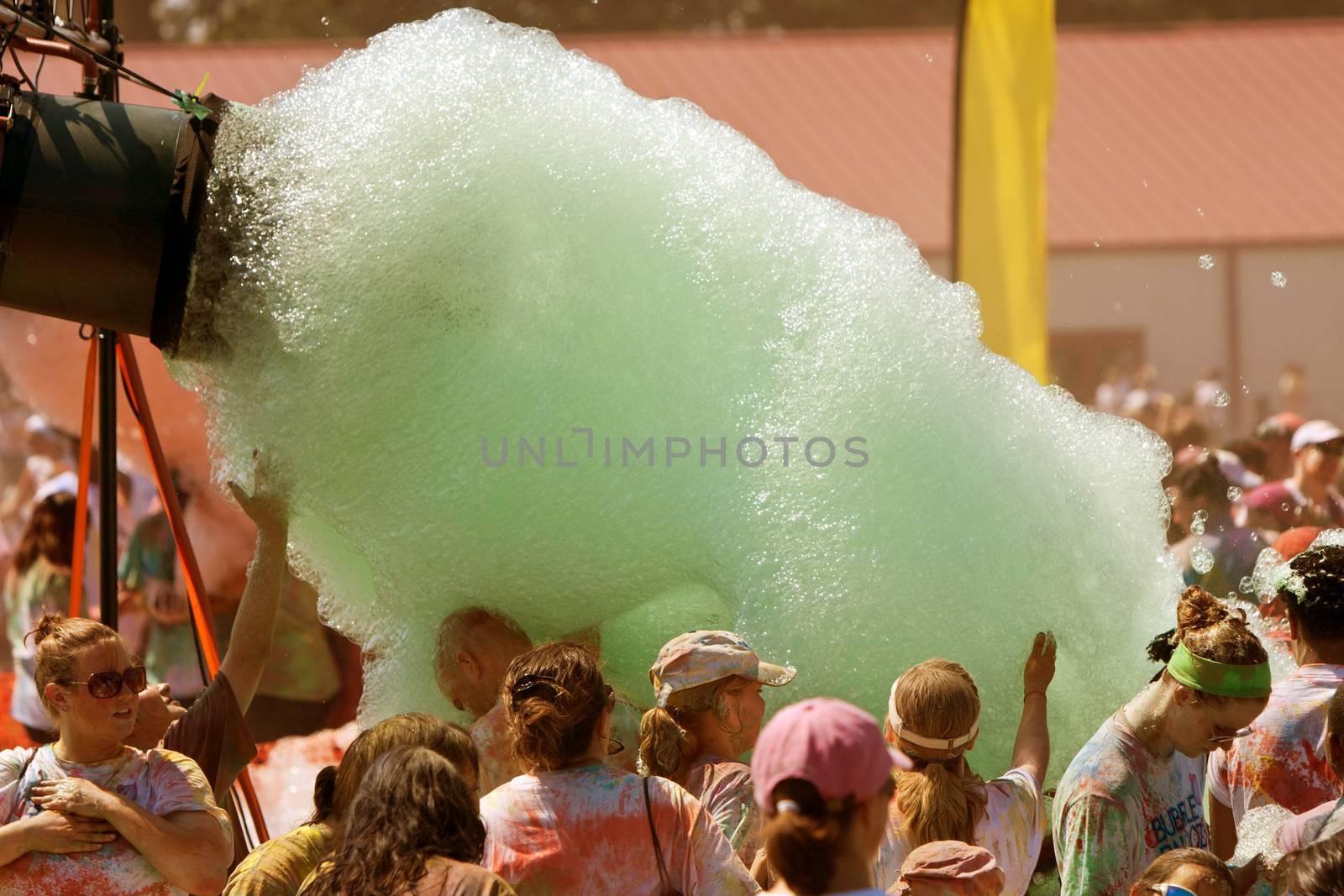 People Walk Through Stream Of Green Foam At Bubble Palooza by BluIz60