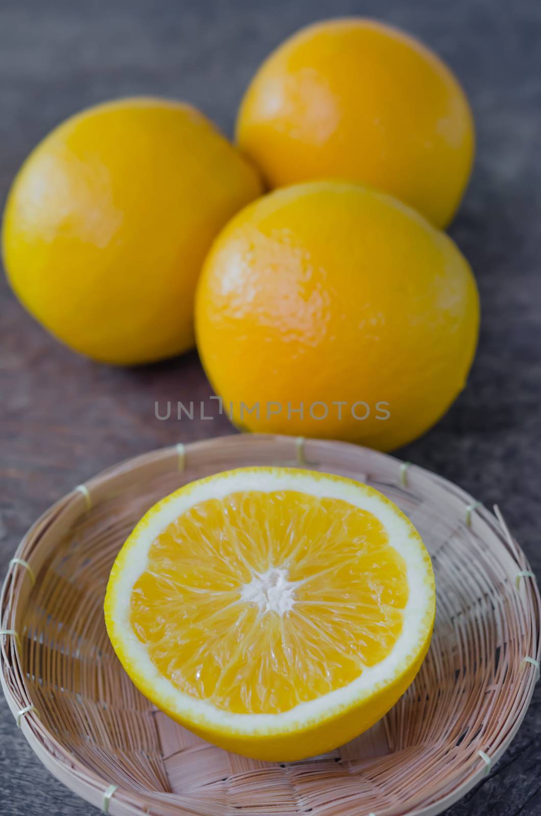 fresh  orange  fruits  and half in basket on wooden background
