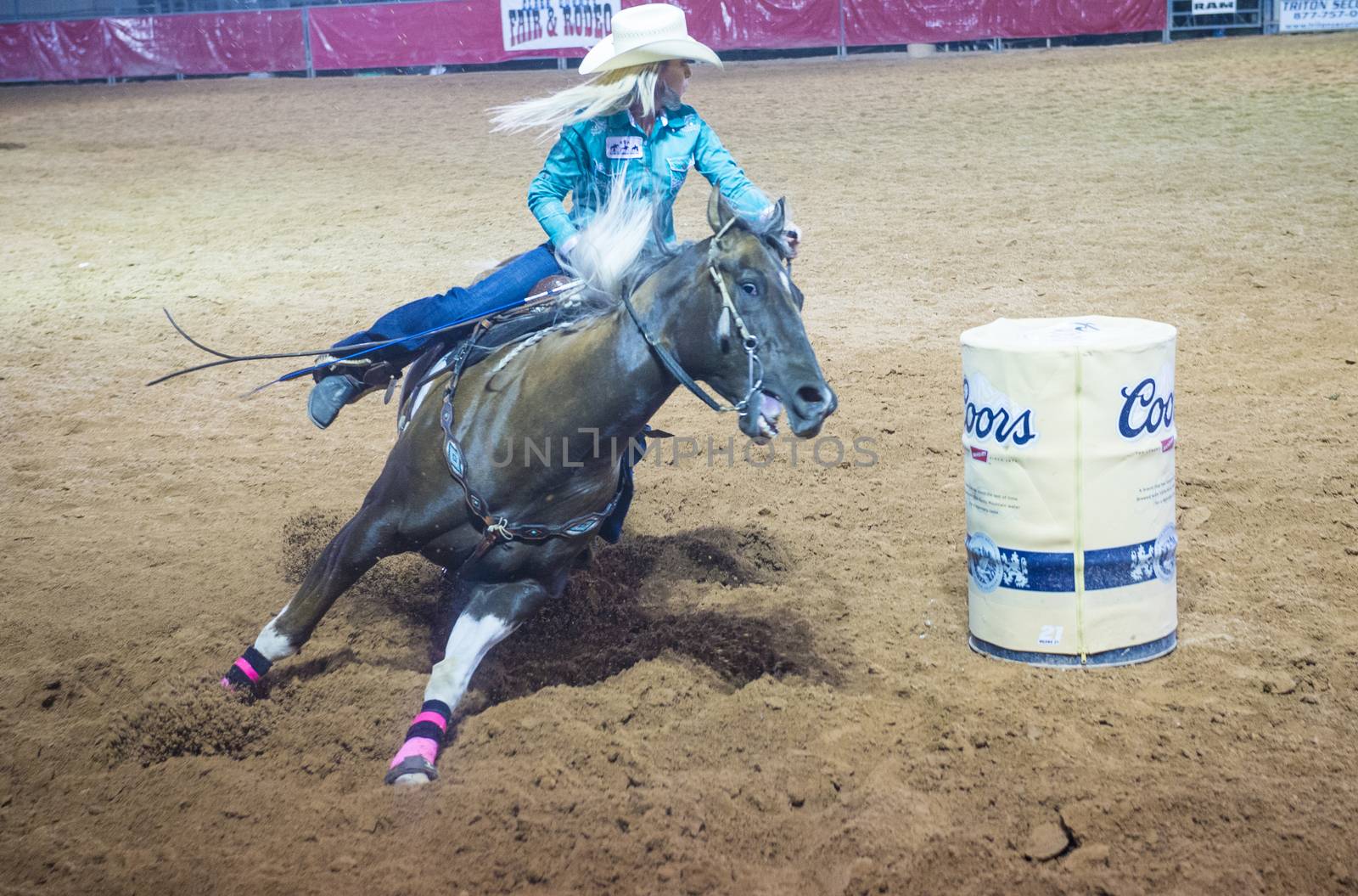 LOGANDALE , NEVADA - APRIL 10 : Cowgirl Participating in a Barrel racing competition in the Clark County Fair and Rodeo a Professional Rodeo held in Logandale Nevada , USA on April 10 2014